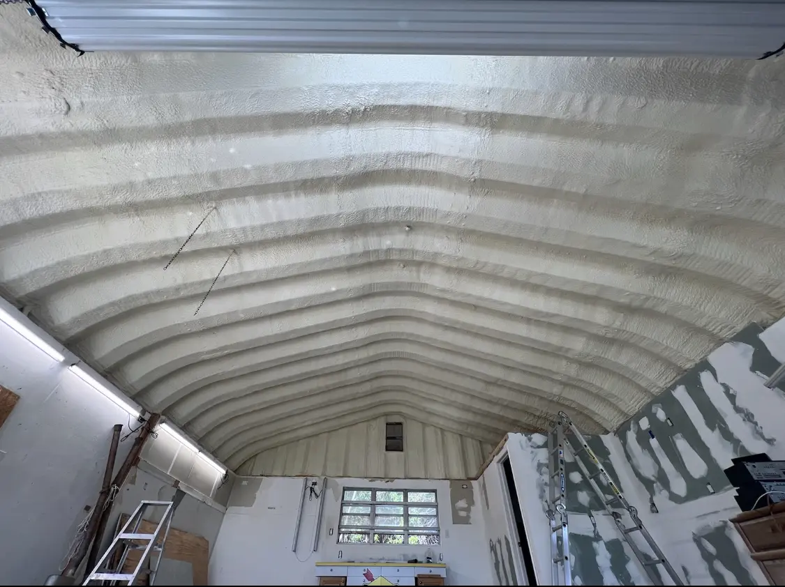 Spray polyurethane foam applied to the underside of a metal roof deck in Sea Cliff